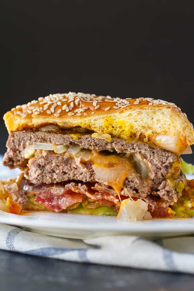 Easy Stuffed Burgers - The easiest stuffed burgers you'll ever make! Tender, juicy and flavorful beef patties are stuffed with cheddar cheese, mushrooms and onions. 