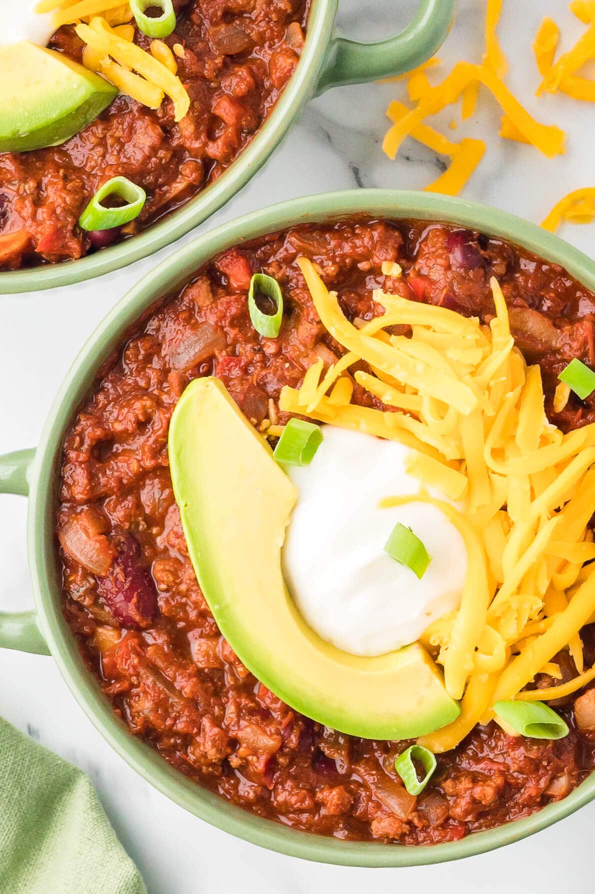 Chili in a bowl with toppings.