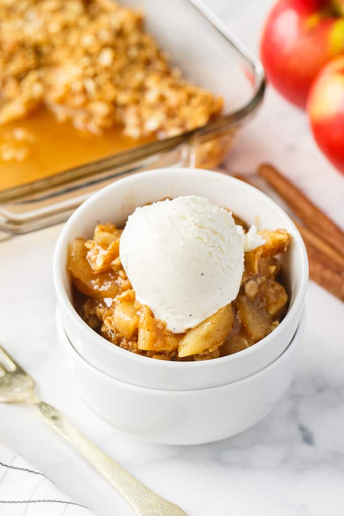 Apple Crisp - This simple old-fashioned dessert is baked with sweet and tart apples and topped with a brown sugar oat crumble. One of the best homemade fall desserts. Serve with vanilla ice cream for extra decadence.