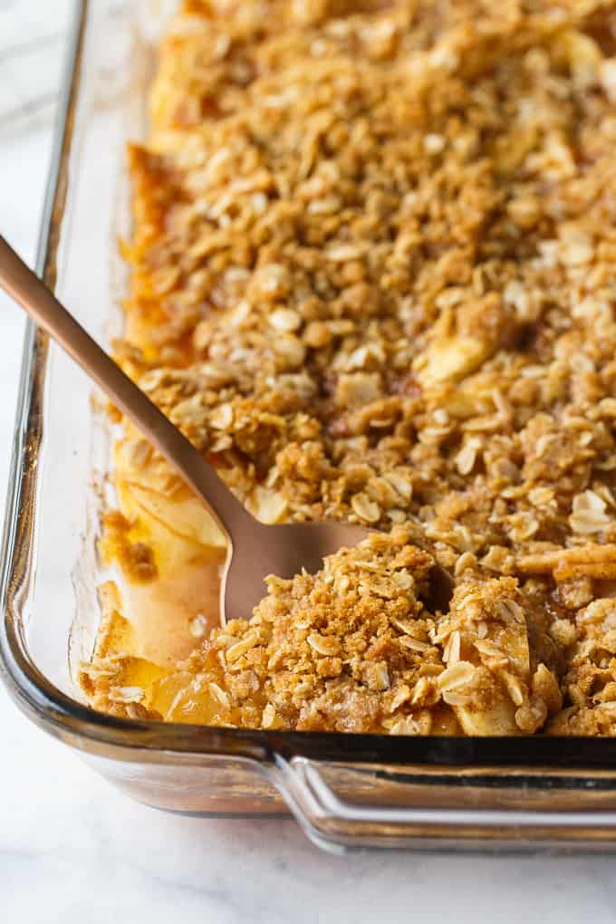 Apple Crisp - This simple old-fashioned dessert is baked with sweet and tart apples and topped with a brown sugar oat crumble. One of the best homemade fall desserts. Serve with vanilla ice cream for extra decadence.