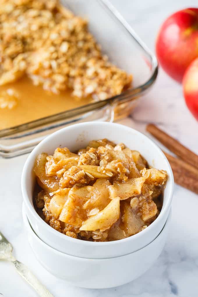 Apple Crisp - This simple old-fashioned dessert is baked with sweet and tart apples and topped with a brown sugar oat crumble. One of the best homemade fall desserts. Serve with vanilla ice cream for extra decadence.