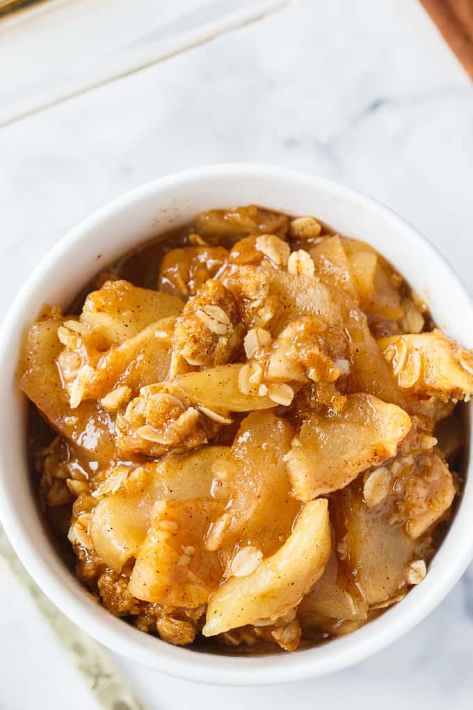 Apple Crisp - This simple old-fashioned dessert is baked with sweet and tart apples and topped with a brown sugar oat crumble. One of the best homemade fall desserts. Serve with vanilla ice cream for extra decadence.
