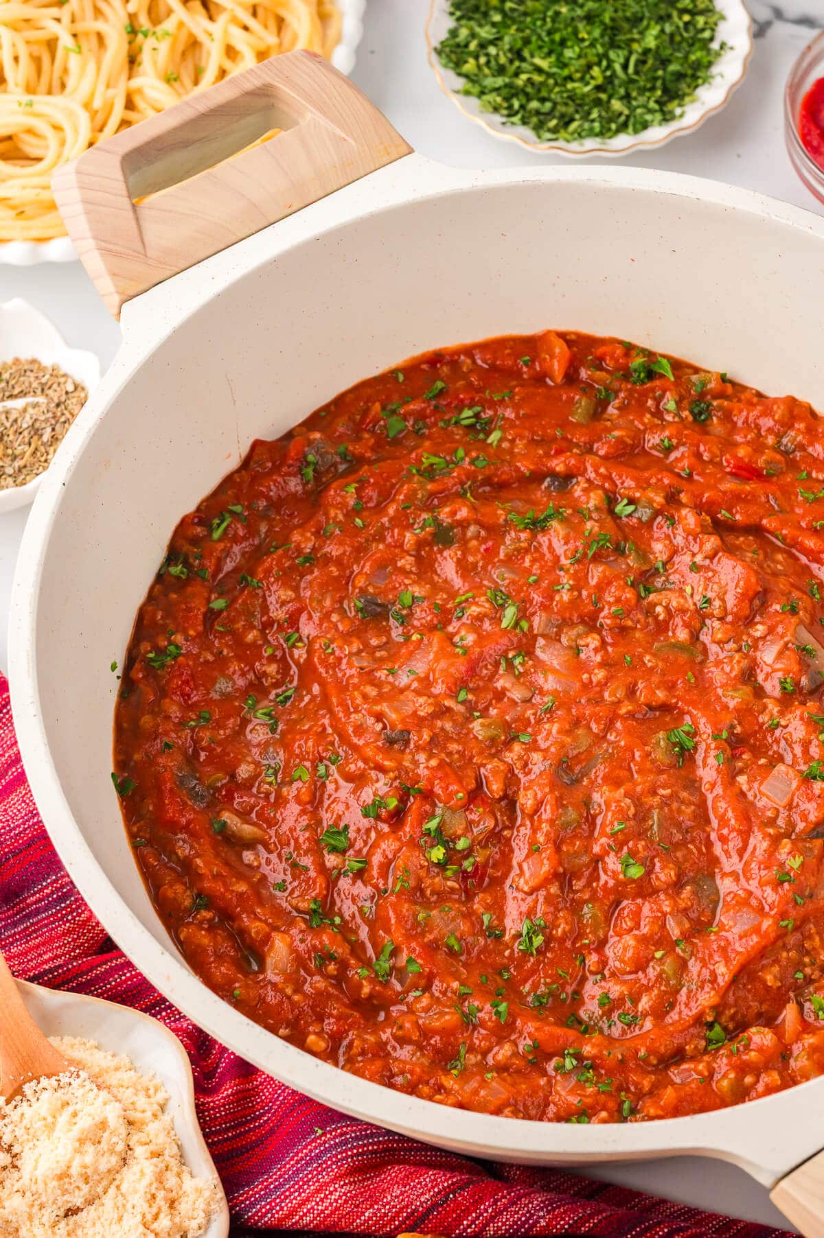 A white pot of homemade spaghetti sauce.