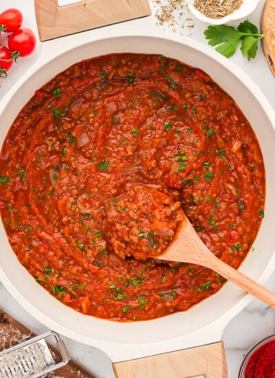 A pot of the recipe with a wooden spoon.