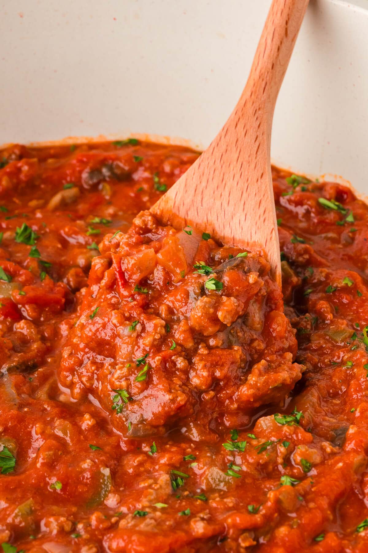 A pot of the recipe with a wooden spoon.