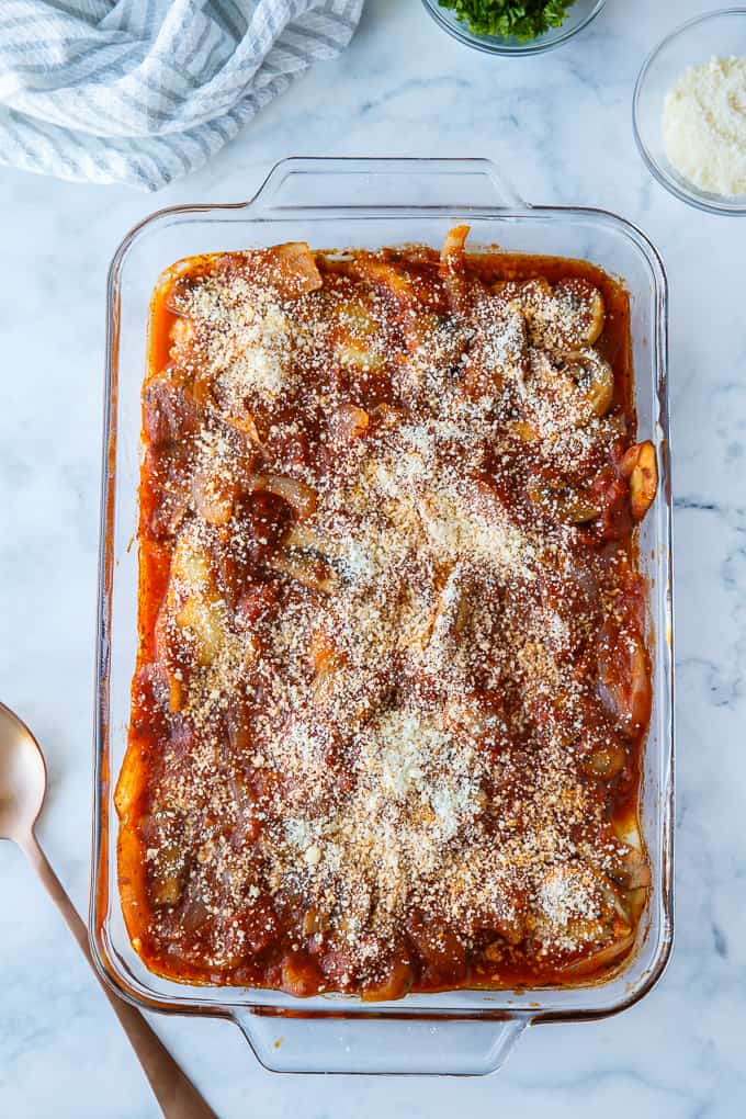 Pierogi Casserole - This baked casserole is a super easy dinner recipe perfect for busy weeknights. Made with frozen pierogis, mushrooms, onions, pasta sauce and topped with Parmesan cheese. It's a family favorite comfort food! 