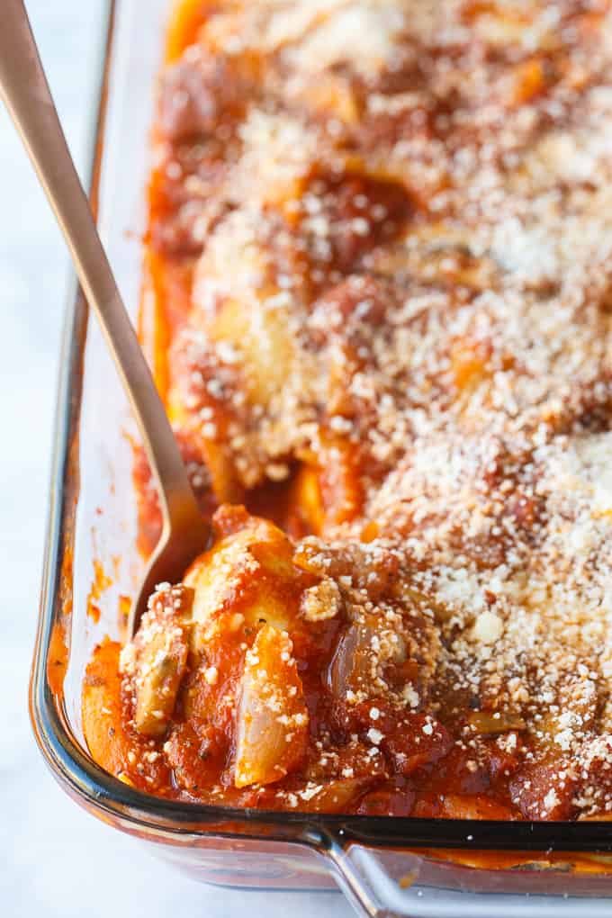 Pierogi Casserole - This baked casserole is a super easy dinner recipe perfect for busy weeknights. Made with frozen pierogis, mushrooms, onions, pasta sauce and topped with Parmesan cheese. It's a family favorite comfort food! 