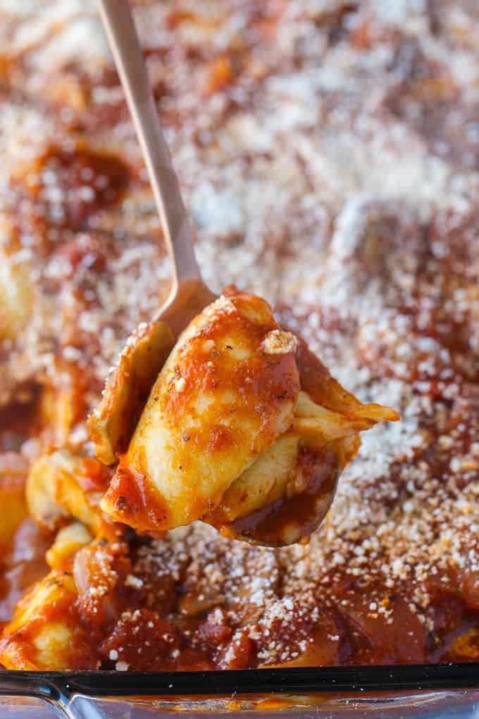 Pierogi Casserole - This baked casserole is a super easy dinner recipe perfect for busy weeknights. Made with frozen pierogis, mushrooms, onions, pasta sauce and topped with Parmesan cheese. It's a family favorite comfort food! 
