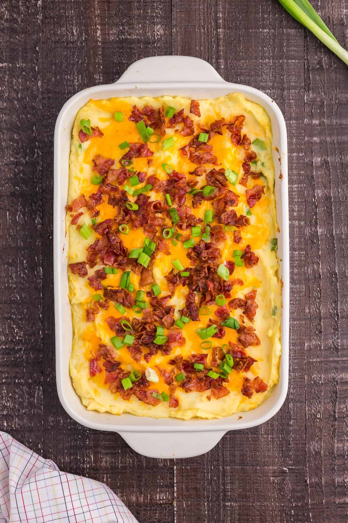 overhead shot of loaded mashed potatoes in a casserole dish