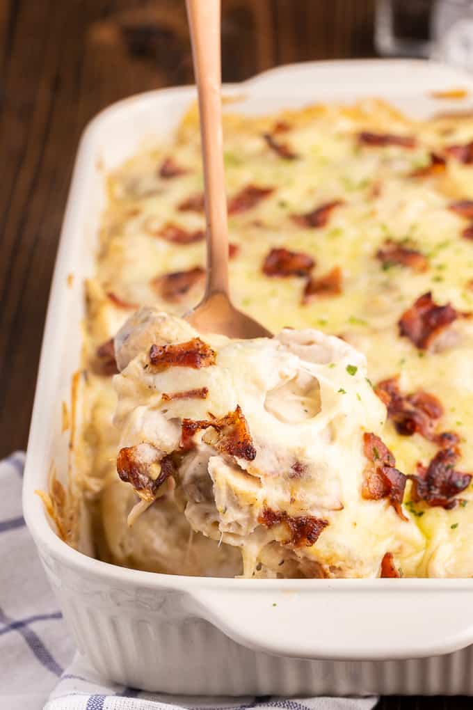 Chicken Alfredo Pierogi Casserole - Everyone who tries this easy baked casserole made from frozen pierogies raves about how amazing it is! This comfort food dinner recipe is loaded with chicken, bacon, Alfredo sauce, onions, mushrooms and pierogies.