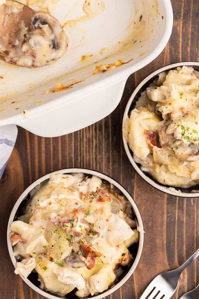Chicken Alfredo Pierogi Casserole - Everyone who tries this easy baked casserole made from frozen pierogies raves about how amazing it is! This comfort food dinner recipe is loaded with chicken, bacon, Alfredo sauce, onions, mushrooms and pierogies.
