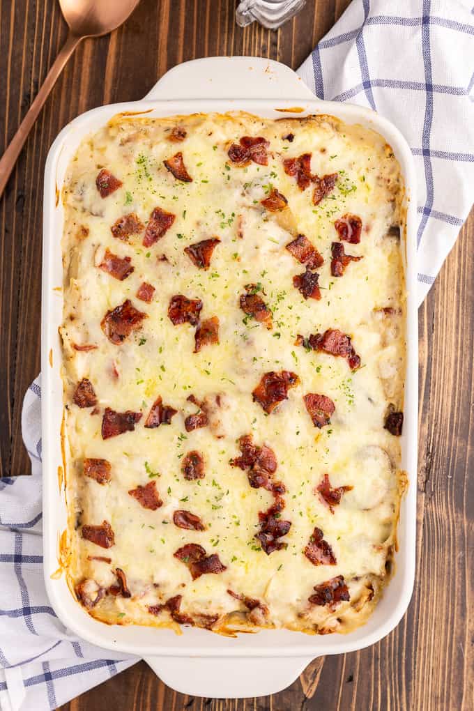 Chicken Alfredo Pierogi Casserole - Everyone who tries this easy baked casserole made from frozen pierogies raves about how amazing it is! This comfort food dinner recipe is loaded with chicken, bacon, Alfredo sauce, onions, mushrooms and pierogies.