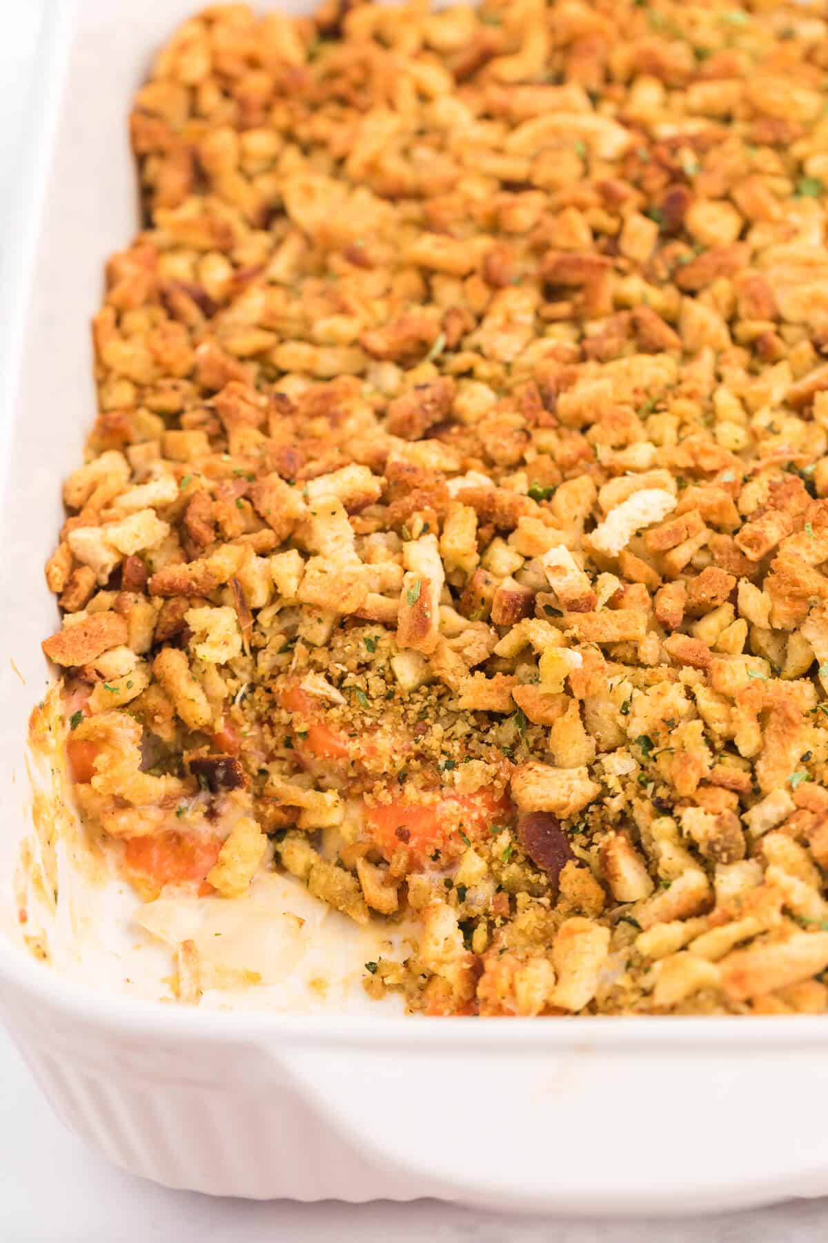 picture of carrot casserole in baking pan with a scoop taken out