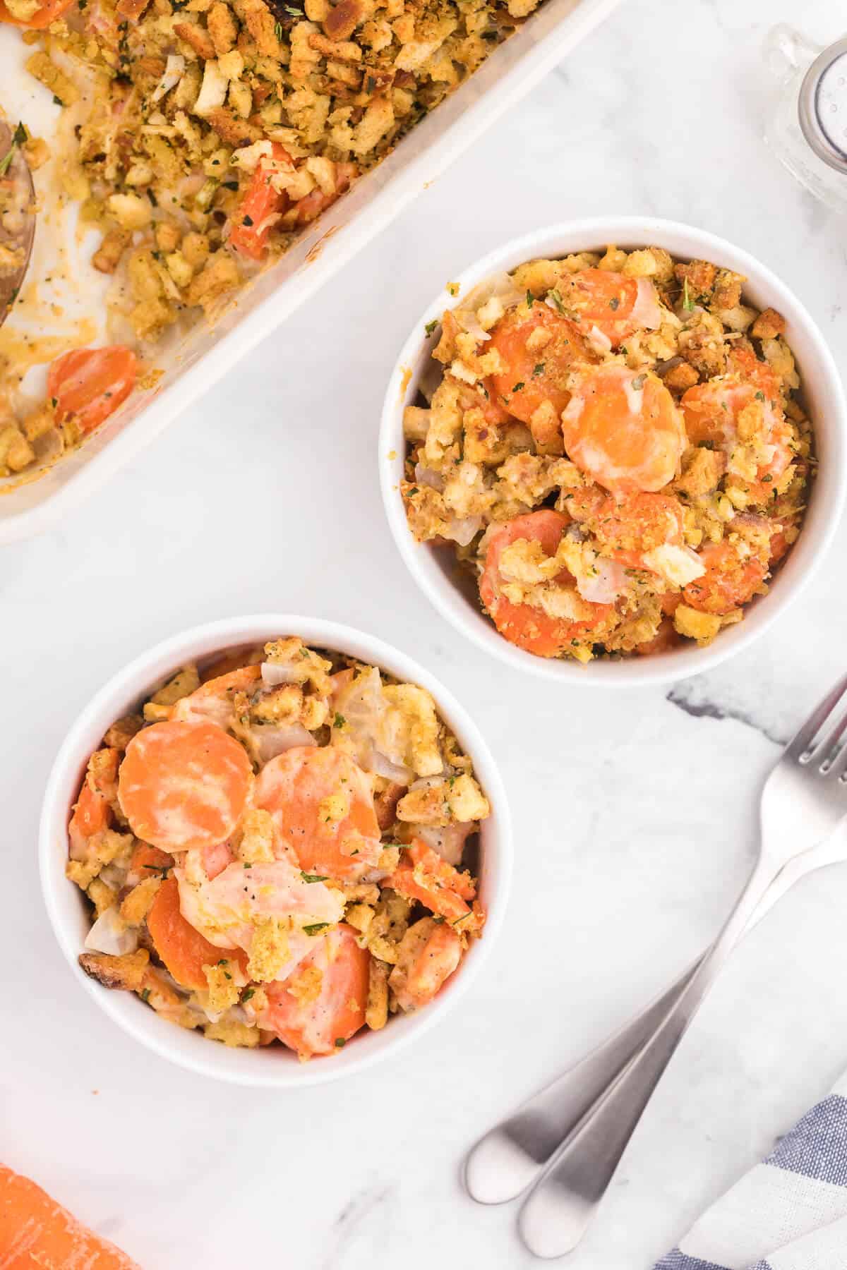 Carrot Casserole - This comforting vegetable side dish recipe is creamy, cheesy with a buttery stuffing topping. Baked to perfection, it's also kid-friendly and a delicious way to get your kids to eat more veggies.