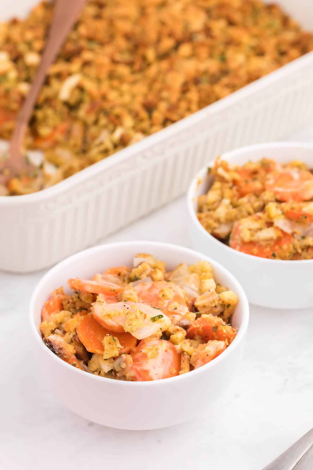 Carrot Casserole - This comforting vegetable side dish recipe is creamy, cheesy with a buttery stuffing topping. Baked to perfection, it's also kid-friendly and a delicious way to get your kids to eat more veggies.