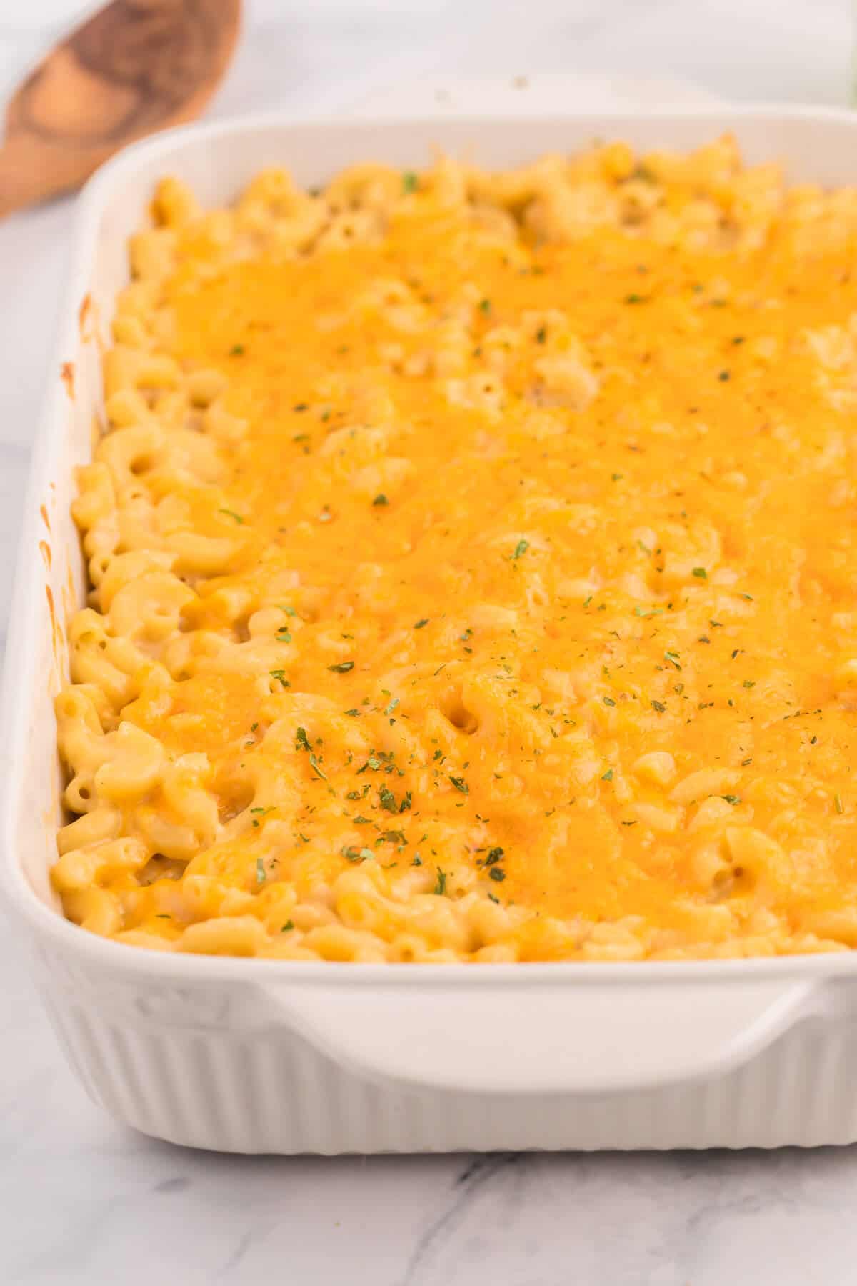 Baked Macaroni and Cheese - This old-fashioned classic recipe is a family favorite dinner and so easy to make. Tender elbow macaroni noodles are enveloped in an ultra creamy homemade cheese sauce and covered with melted cheddar cheese.