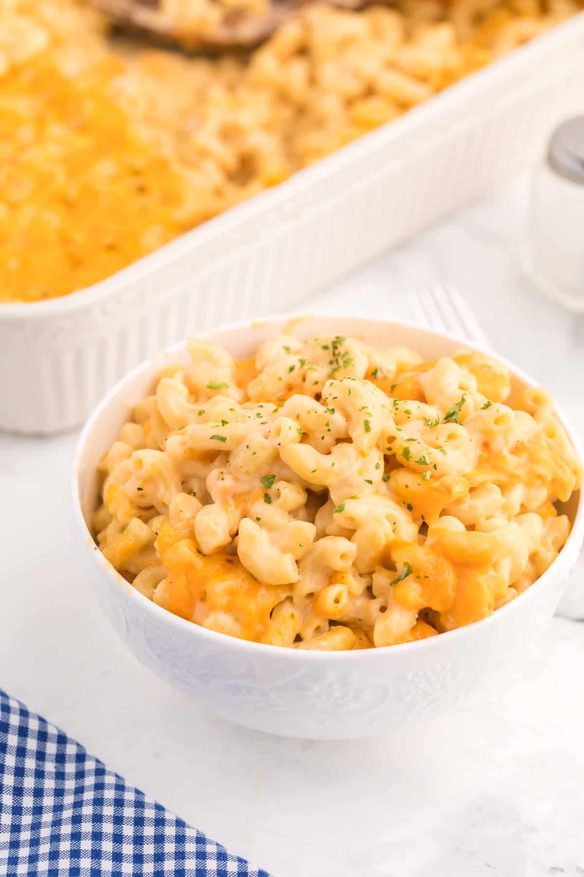 Baked Macaroni and Cheese - This old-fashioned classic recipe is a family favorite dinner and so easy to make. Tender elbow macaroni noodles are enveloped in an ultra creamy homemade cheese sauce and covered with melted cheddar cheese.