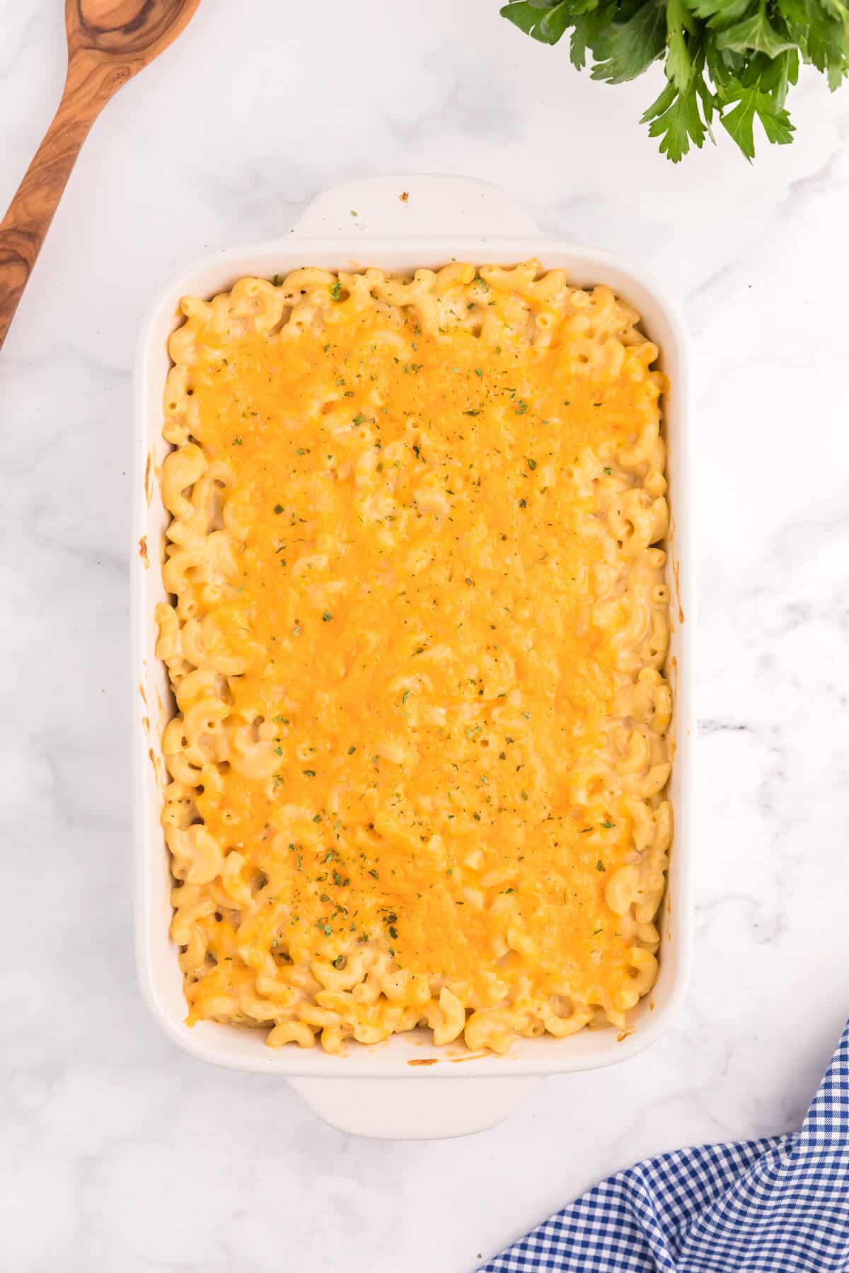 Baked Macaroni and Cheese - This old-fashioned classic recipe is a family favorite dinner and so easy to make. Tender elbow macaroni noodles are enveloped in an ultra creamy homemade cheese sauce and covered with melted cheddar cheese.