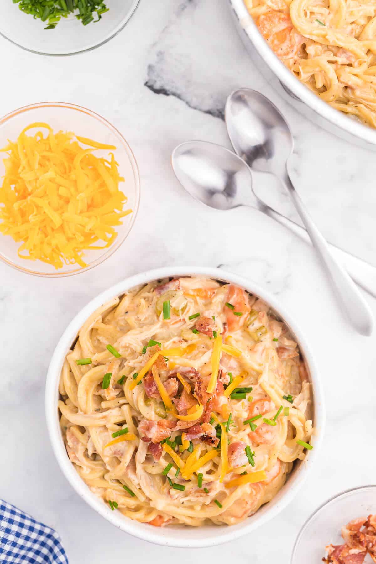 Crack Chicken Spaghetti Recipe - One bite and you'll be hooked! This easy and delicious dinner recipe is creamy, cheesy and addictive. It's loaded with chicken, bacon, veggies and spaghetti noodles in a flavorful cream cheese based sauce.