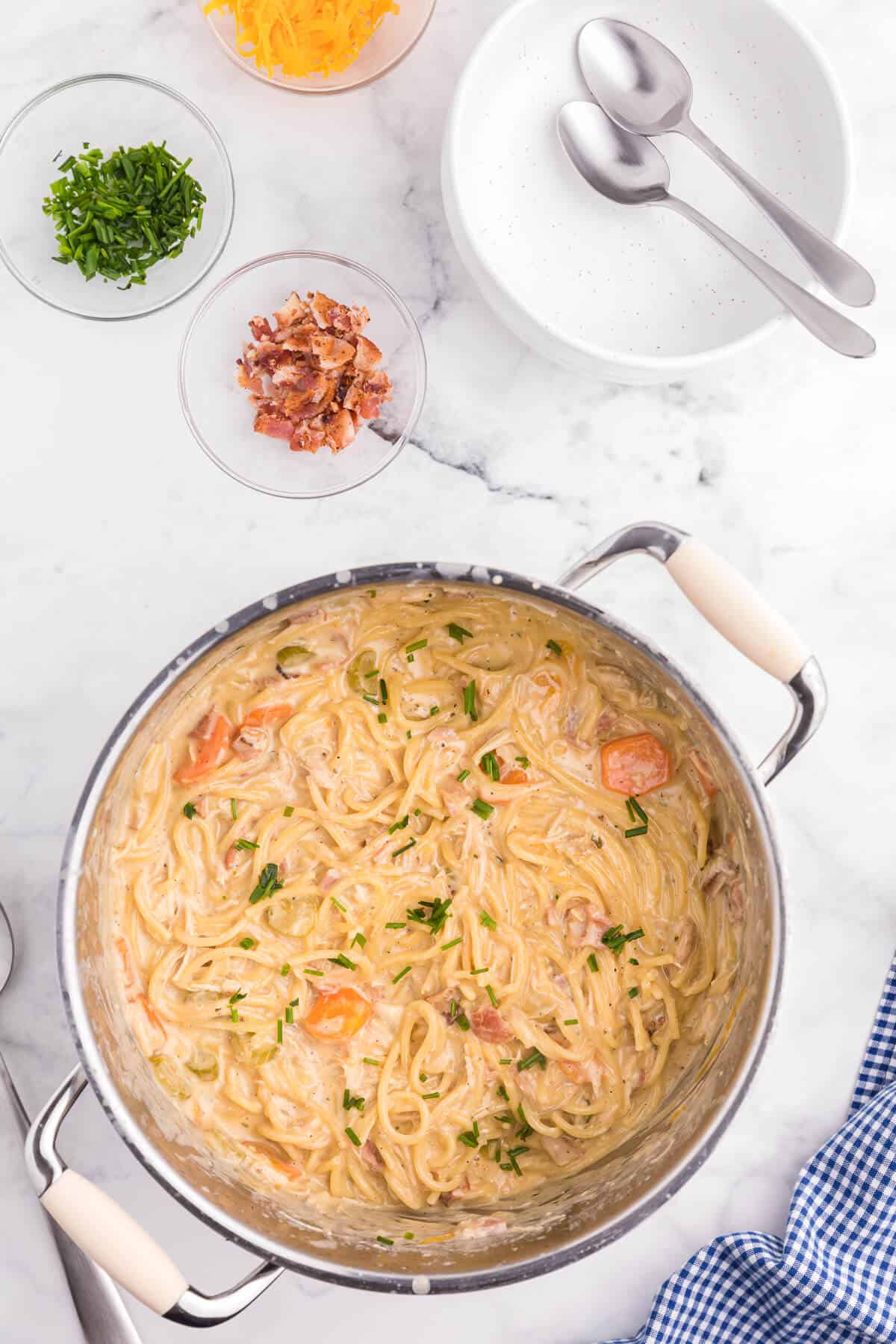 Crack Chicken Spaghetti Recipe - One bite and you'll be hooked! This easy and delicious dinner recipe is creamy, cheesy and addictive. It's loaded with chicken, bacon, veggies and spaghetti noodles in a flavorful cream cheese based sauce.