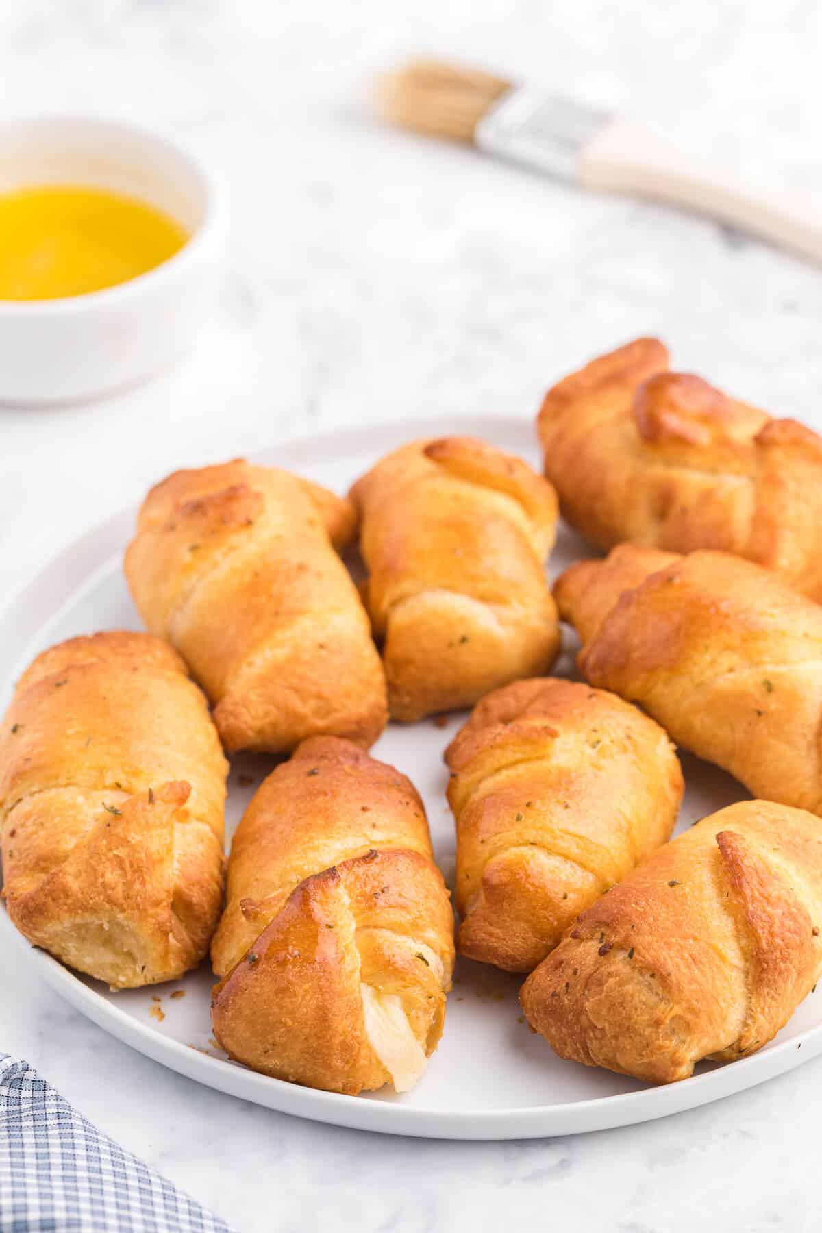 Air Fryer Garlic Cheese Stuffed Crescent Rolls Recipe - Use your air fryer to make this quick and easy snack or appetizer. Pillsbury crescent roll dough is brushed with garlic butter and wrapped around mozzarella cheese. Warning: they are addictive!