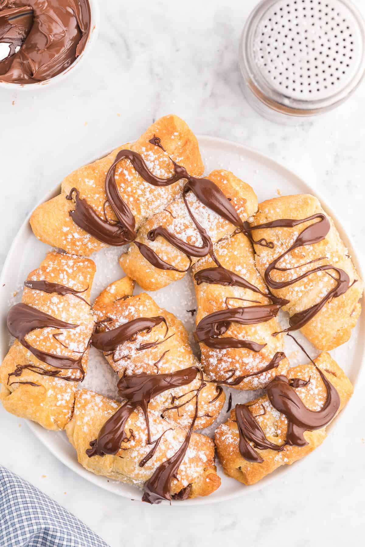 Air Fryer Chocolate Crescent Rolls Recipe - Make these chocolate stuffed crescent rolls in your air fryer. Wrap Pillsbury crescent roll dough around a spoonful of sweet and rich Nutella. Ready to eat in minutes! Such a delicious and easy dessert everyone loves.