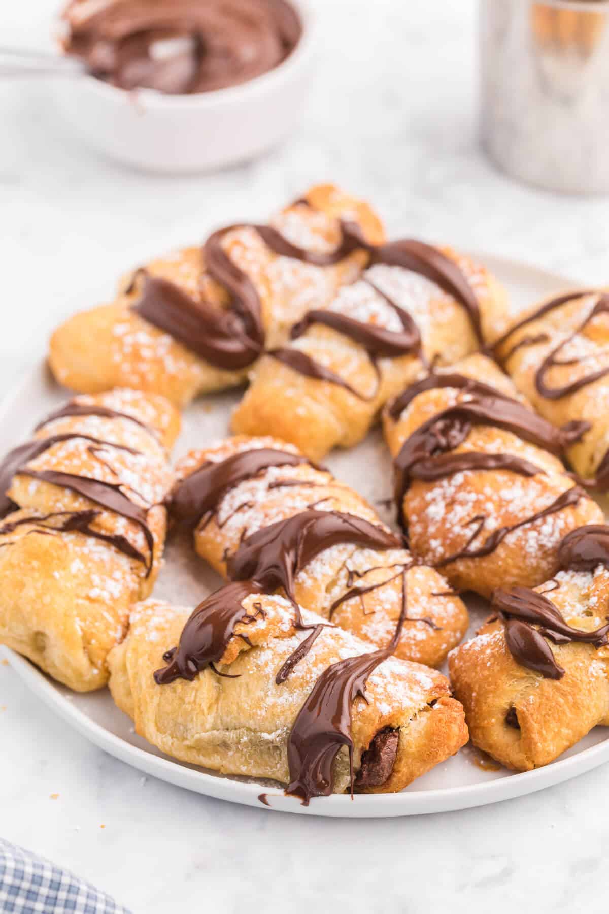 Air Fryer Chocolate Crescent Rolls Recipe - Make these chocolate stuffed crescent rolls in your air fryer. Wrap Pillsbury crescent roll dough around a spoonful of sweet and rich Nutella. Ready to eat in minutes! Such a delicious and easy dessert everyone loves.
