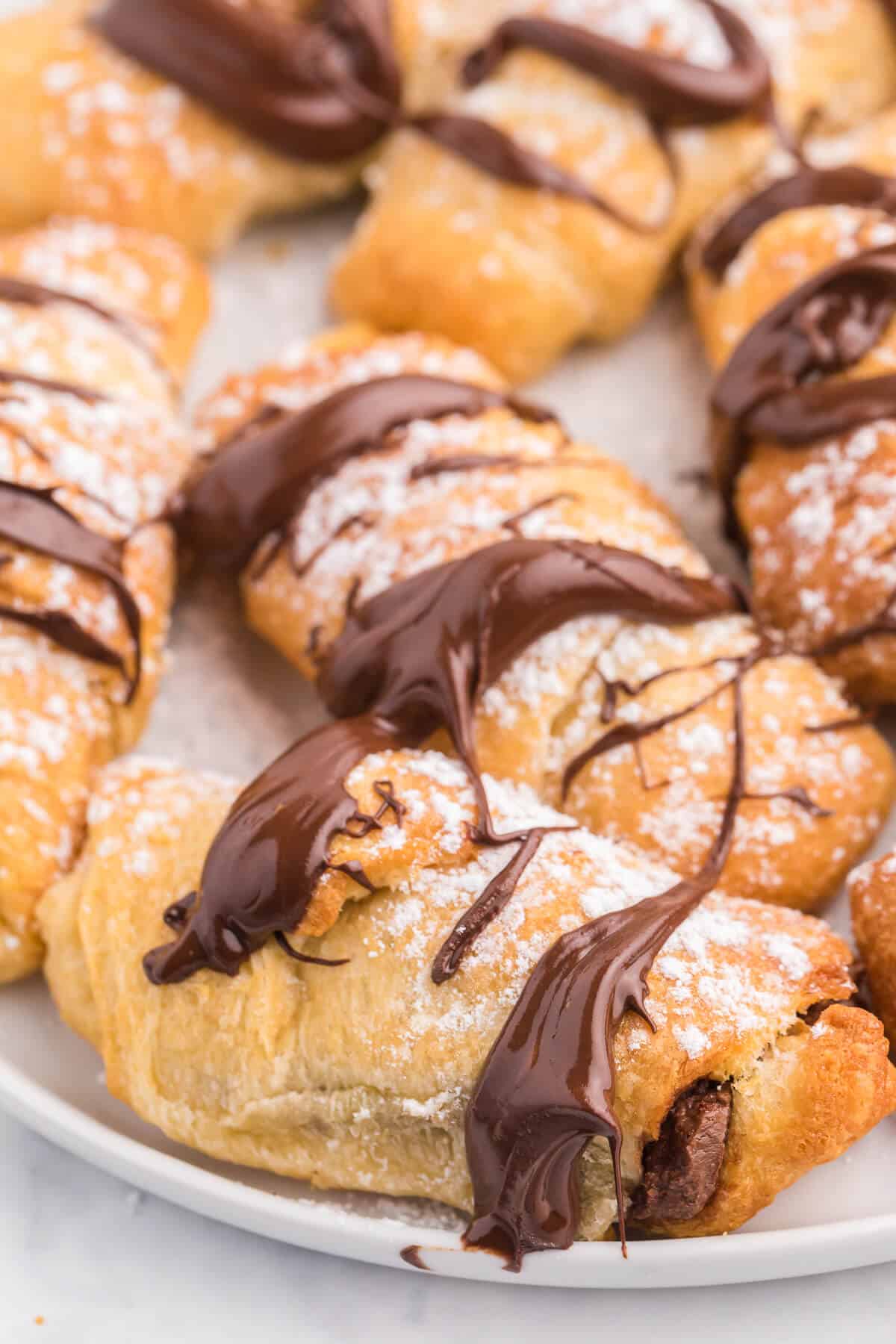 Air Fryer Chocolate Crescent Rolls Recipe - Make these chocolate stuffed crescent rolls in your air fryer. Wrap Pillsbury crescent roll dough around a spoonful of sweet and rich Nutella. Ready to eat in minutes! Such a delicious and easy dessert everyone loves.