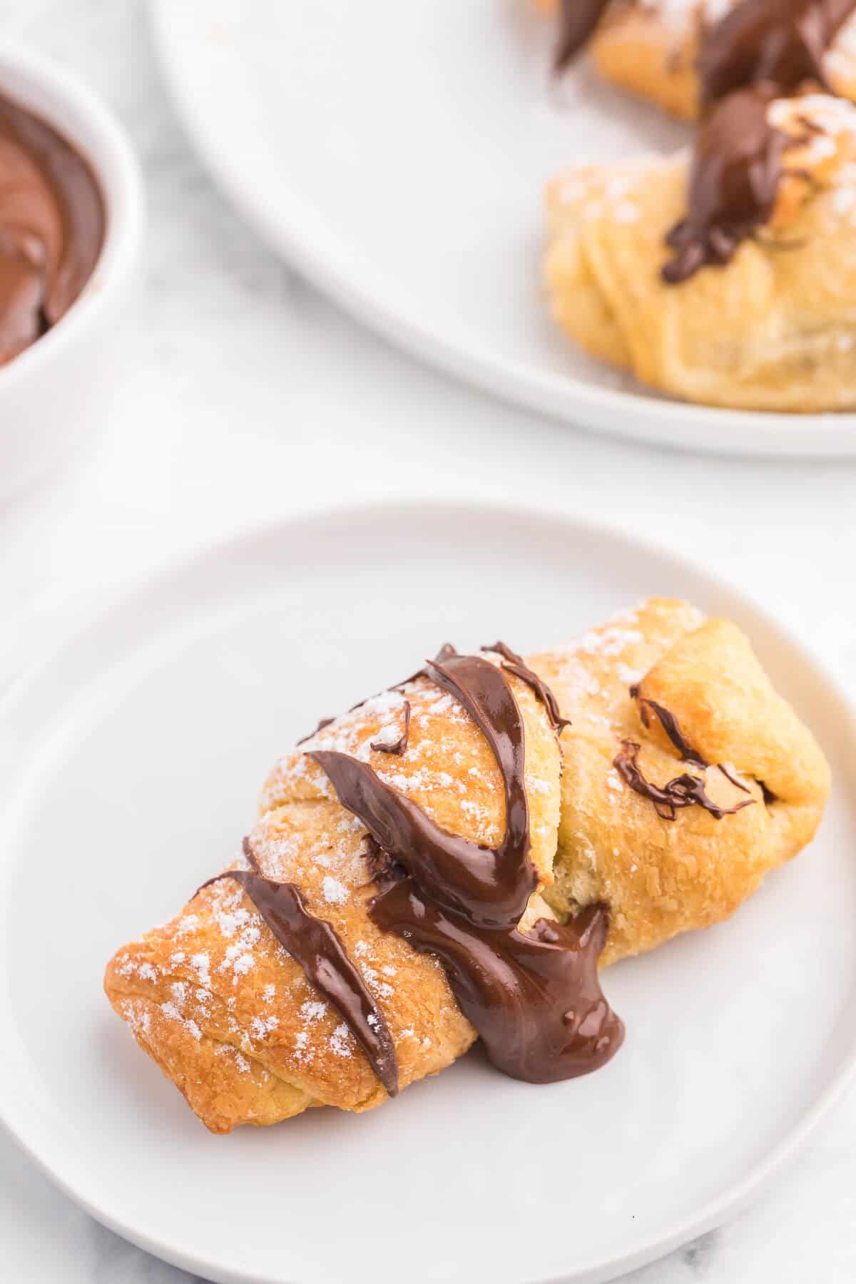 Air Fryer Chocolate Crescent Rolls Recipe - Make these chocolate stuffed crescent rolls in your air fryer. Wrap Pillsbury crescent roll dough around a spoonful of sweet and rich Nutella. Ready to eat in minutes! Such a delicious and easy dessert everyone loves.