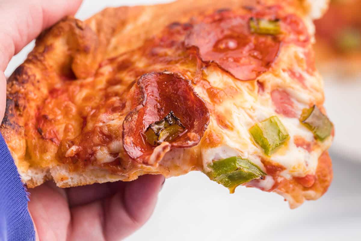 Air Fryer Pizza Recipe - Use premade pizza dough to make this better than delivery pizza right in your air fryer! This recipe makes two individual pizzas that are ready to eat in minutes.