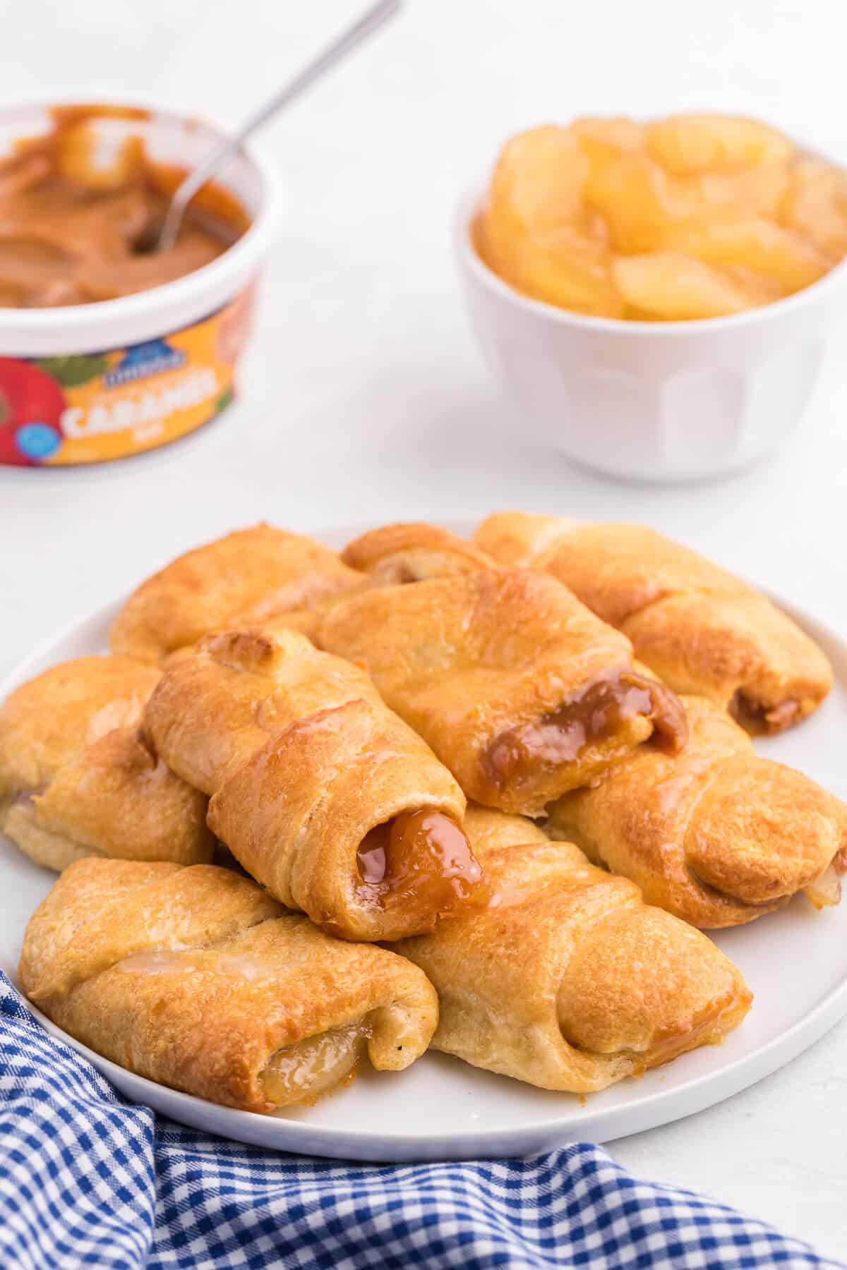 Caramel Apple Pie Crescents - The most simple apple dessert made in your air fryer in minutes! Buttery golden crescent roll pastry is wrapped around sweet apple pie filling and caramel with a sugar drizzle on top.