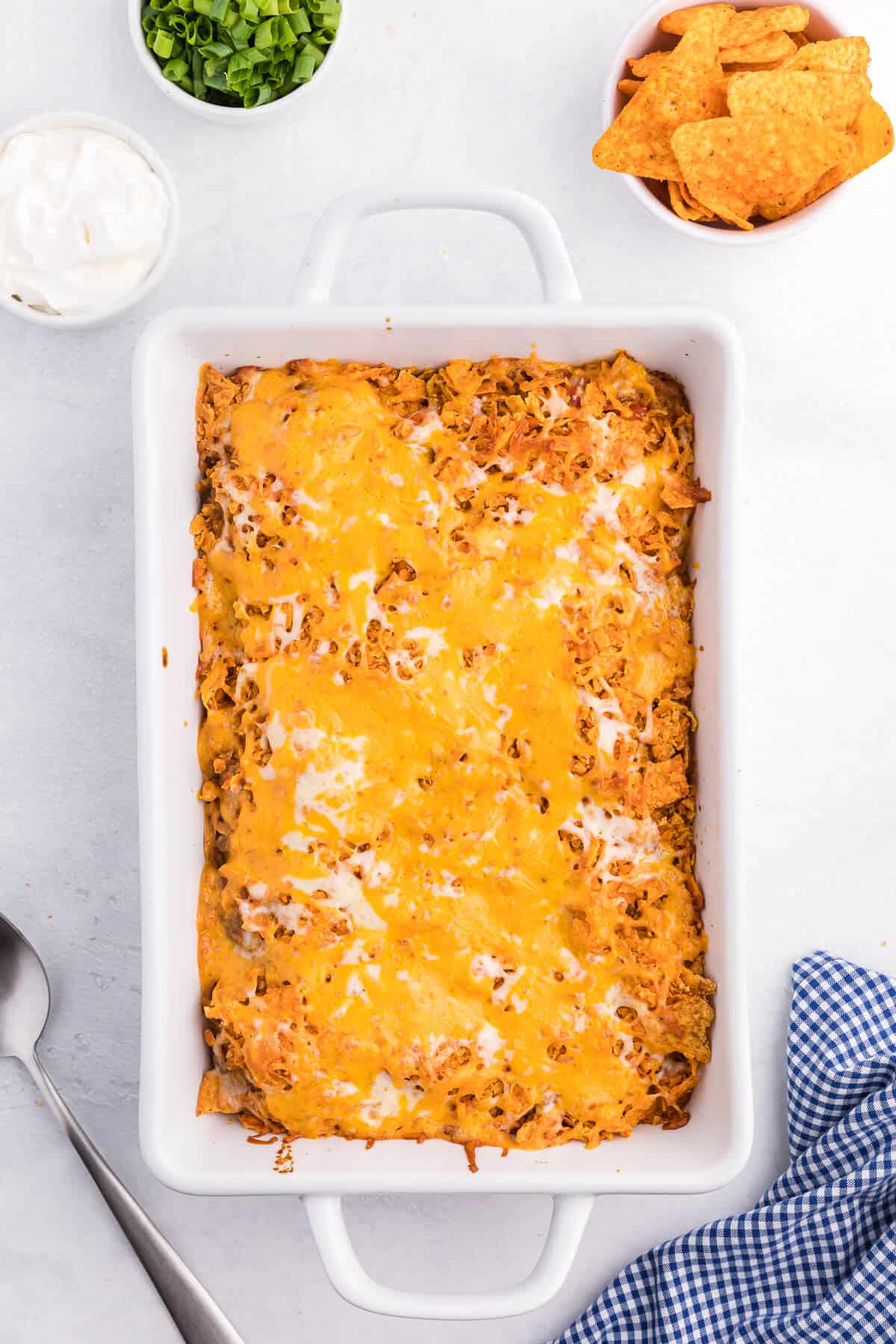 Doritos Casserole Recipe - Take Mexican night to a whole new level with this easy taco bake recipe. Made with ground beef, sour cream, spices and loads of cheese, it's zesty with hearty Tex Mex flavor. A yummy dinner recipe your family will love!