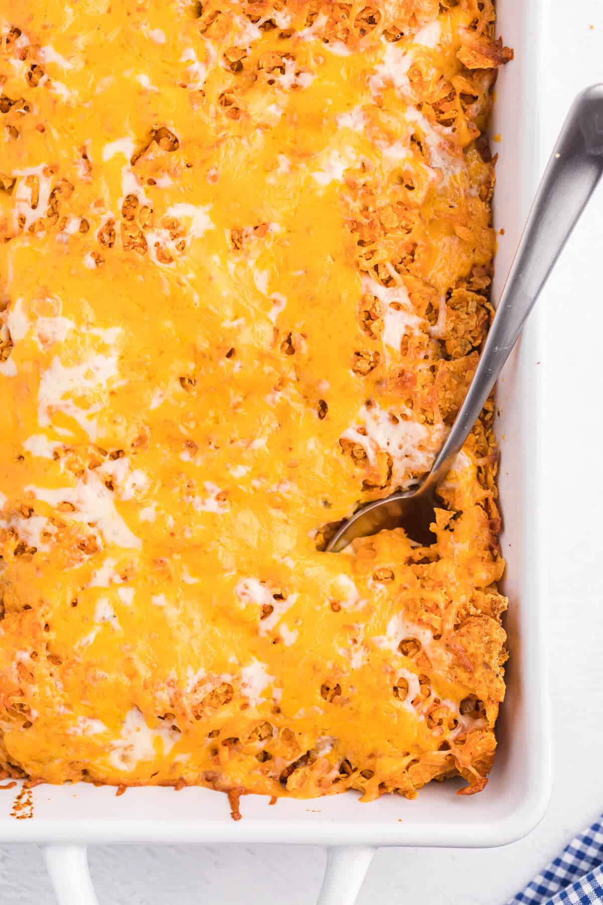 Doritos Casserole Recipe - Take Mexican night to a whole new level with this easy taco bake recipe. Made with ground beef, sour cream, spices and loads of cheese, it's zesty with hearty Tex Mex flavor. A yummy dinner recipe your family will love!