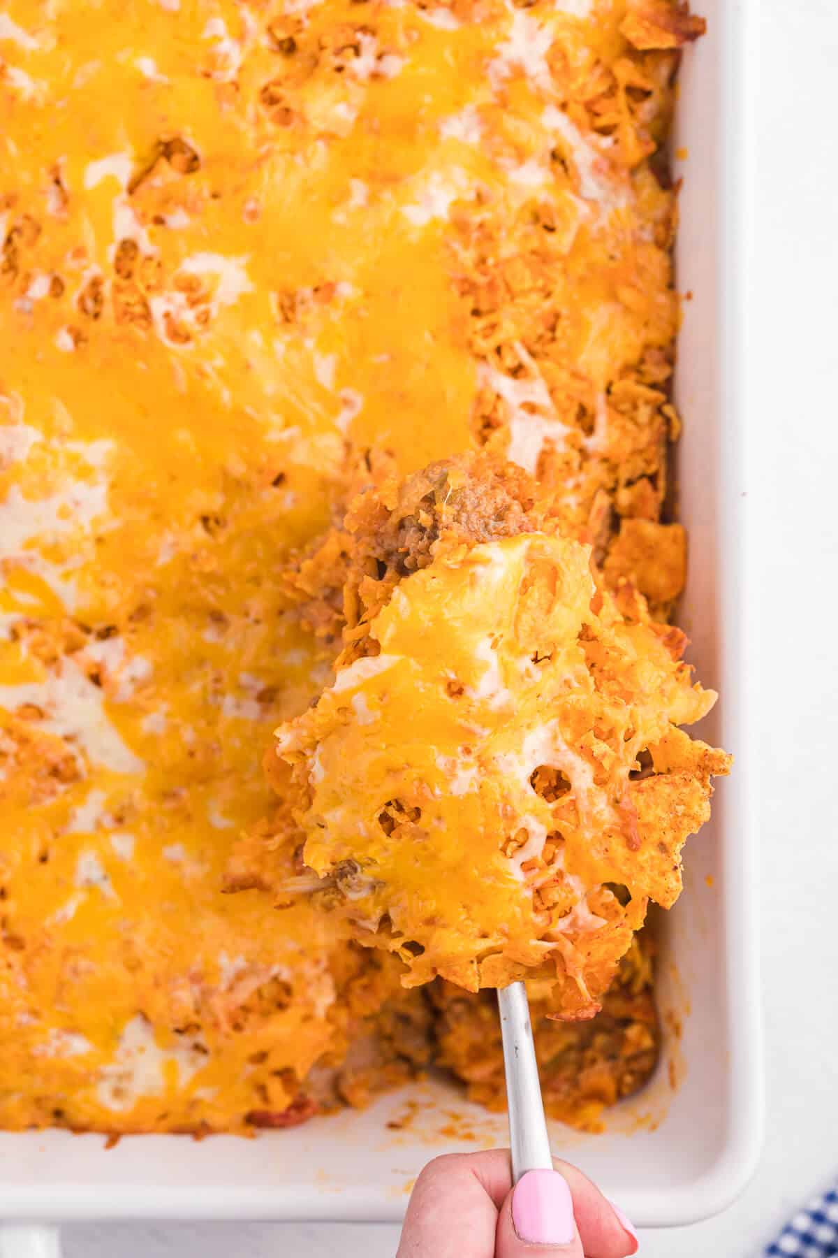 Doritos Casserole Recipe - Take Mexican night to a whole new level with this easy taco bake recipe. Made with ground beef, sour cream, spices and loads of cheese, it's zesty with hearty Tex Mex flavor. A yummy dinner recipe your family will love!