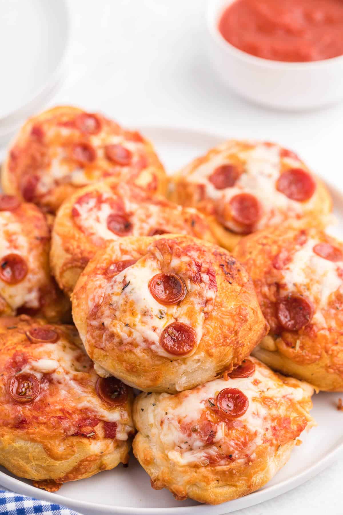 Air Fryer Pizza Buns - This simple recipe is perfect for snacking, an appetizer or for your kids' school lunch. Air fried to golden perfection, these savory buns are easy to make with refrigerated dough, pizza sauce, mozzarella cheese and pepperoni.