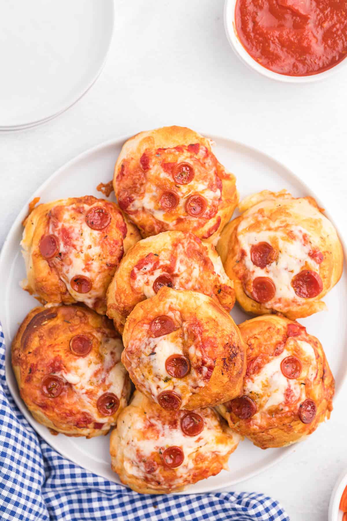 Air Fryer Pizza Buns - This simple recipe is perfect for snacking, an appetizer or for your kids' school lunch. Air fried to golden perfection, these savory buns are easy to make with refrigerated dough, pizza sauce, mozzarella cheese and pepperoni.