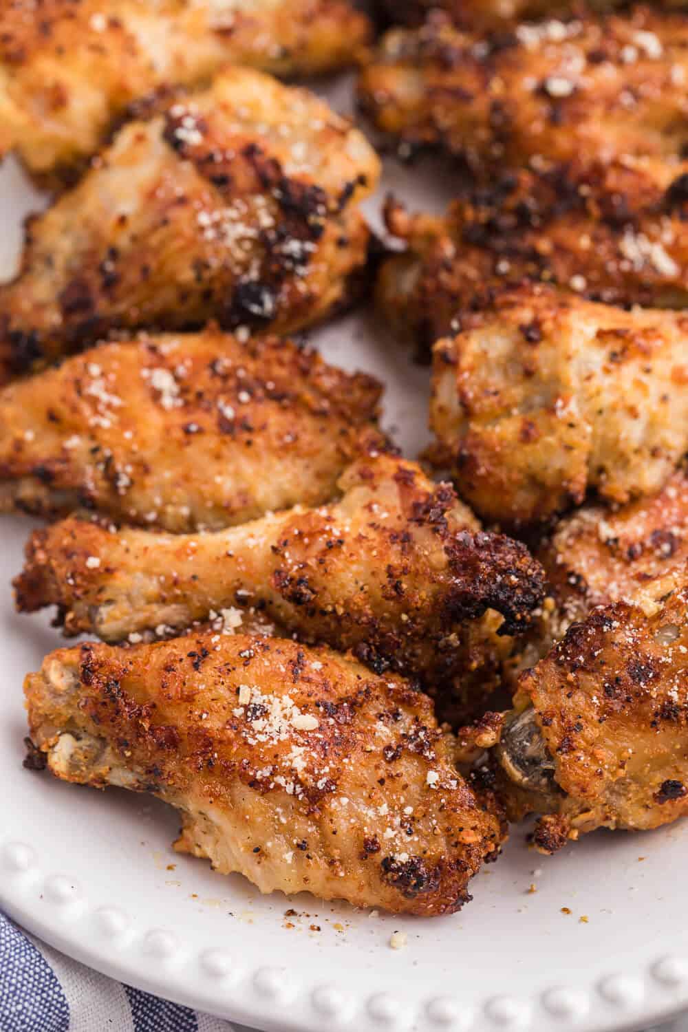 Air Fryer Chicken Wings Recipe - Use your air fryer to make the best crispy chicken wings in minutes! This easy appetizer is covered in a garlic, lemon pepper and Parmesan marinade for the most delicious flavor.