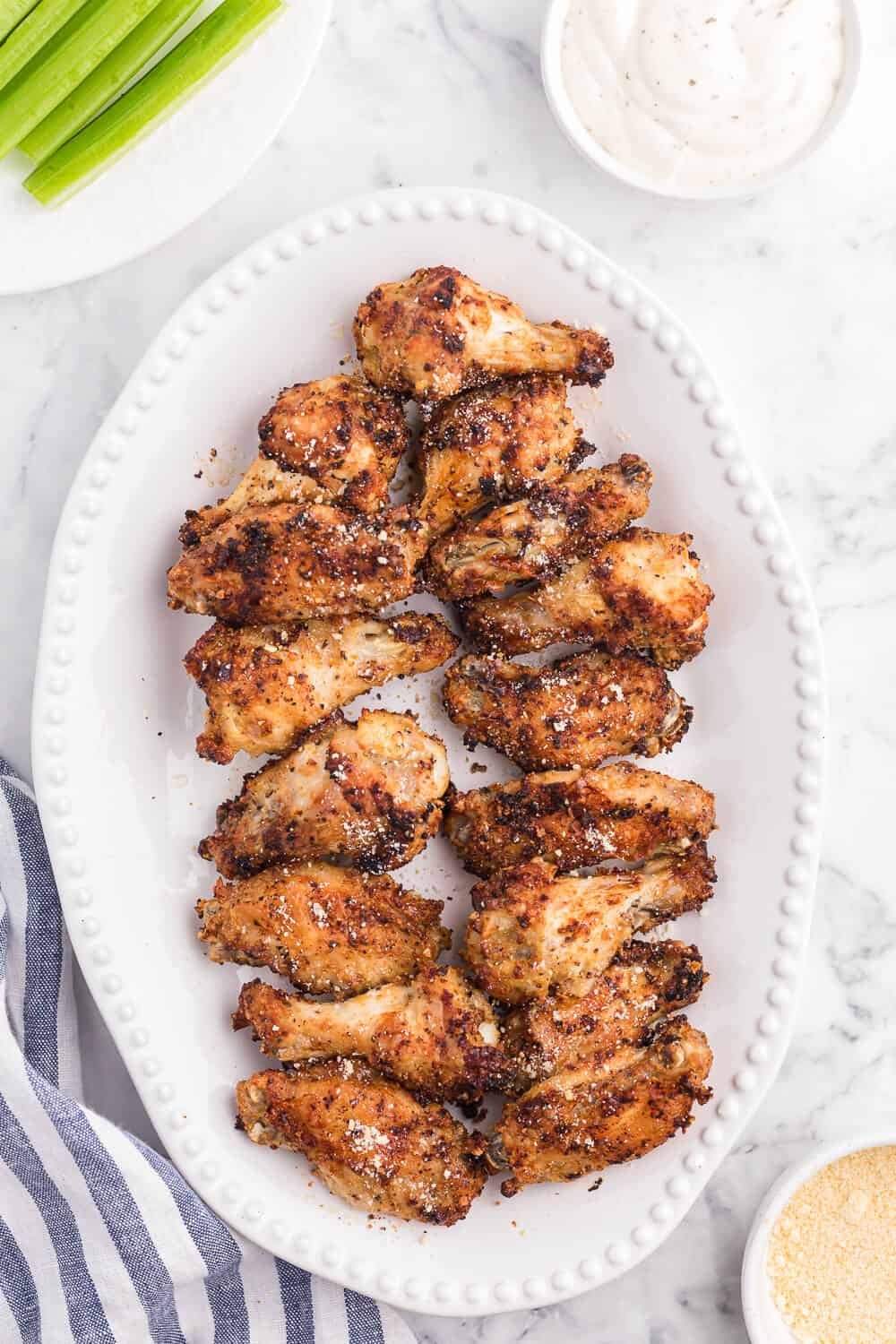Air Fryer Chicken Wings Recipe - Use your air fryer to make the best crispy chicken wings in minutes! This easy appetizer is covered in a garlic, lemon pepper and Parmesan marinade for the most delicious flavor.