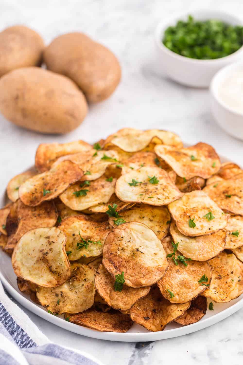 Air Fryer Potato Chips Recipe - These crispy homemade potato chips are super easy to make in the air fryer. Perfect for when you're craving a salty, crunchy snack with loads of flavor!