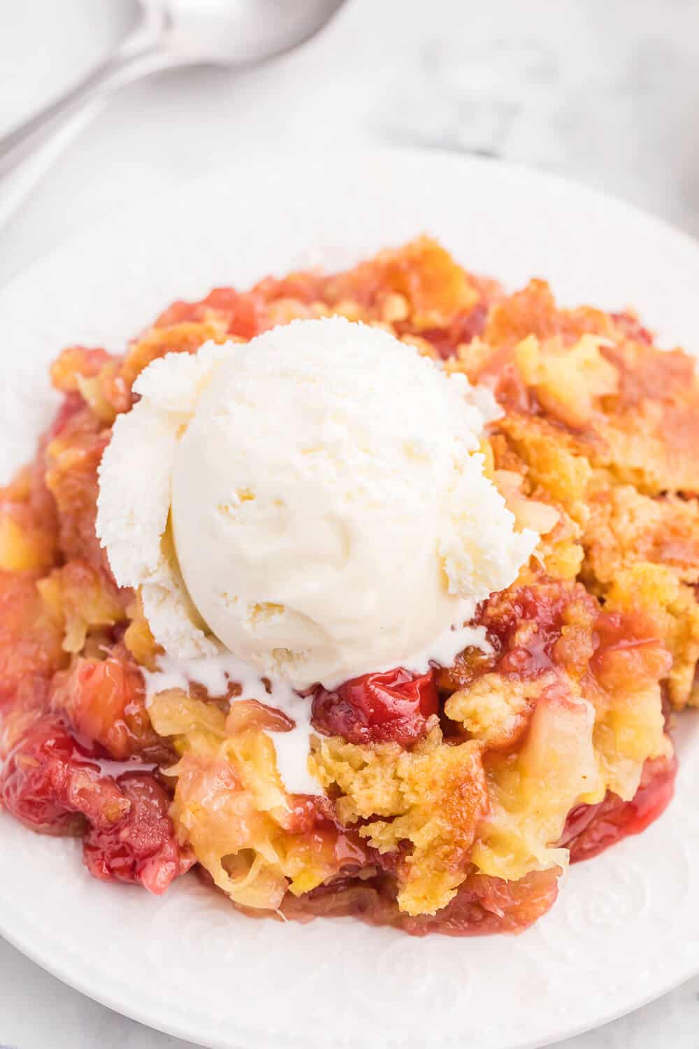 Cherry Pineapple Dump Cake Recipe - Made in 1 pan and only 4 ingredients in this quick and easy dessert recipe. Short prep time and no mixing! Perfect for potlucks and cookouts.