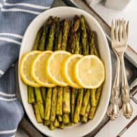 The recipe in a white dish topped with lemon slices.