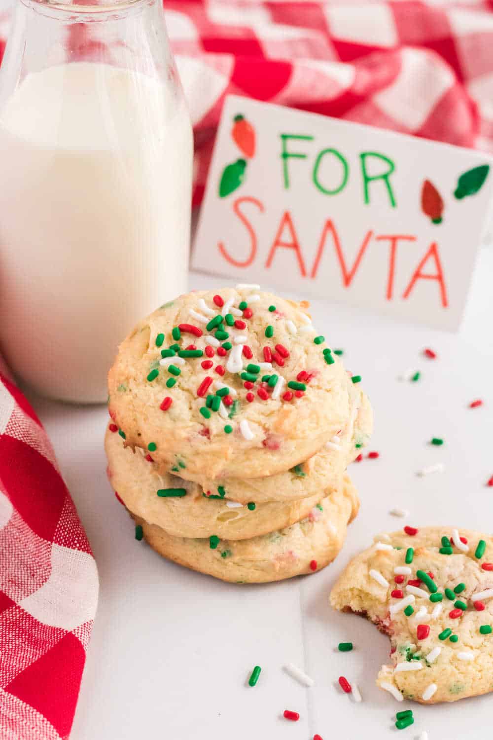 a stack of christmas cake mix cookies with milk