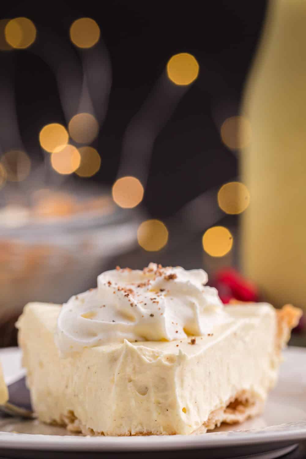 a slice of eggnog pie on a plate with a bite off the end