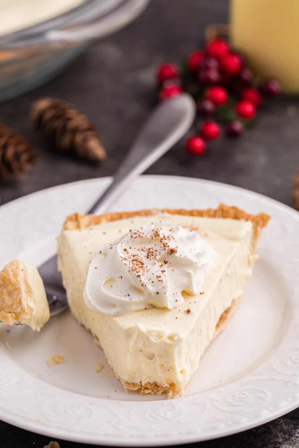 A slice of eggnog pie on a plate with a fork