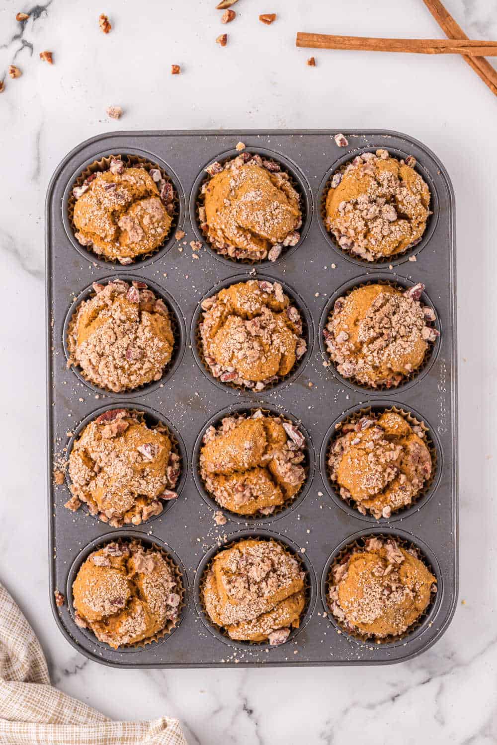 pumpkin crumb muffins in a muffin pan