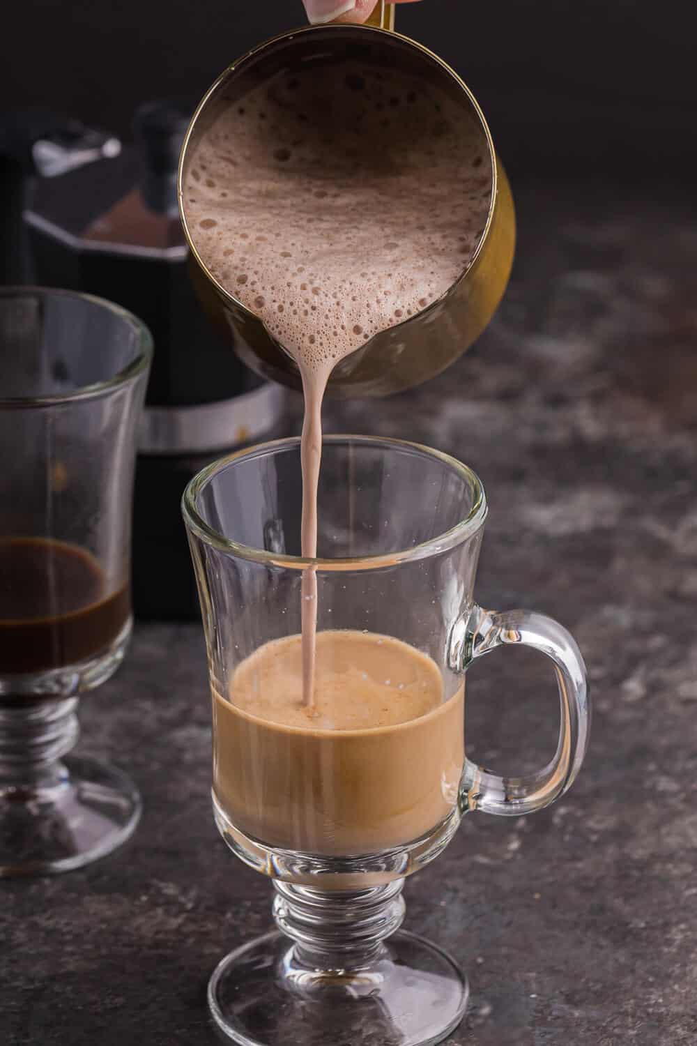 Pouring the cream portion into the mug.