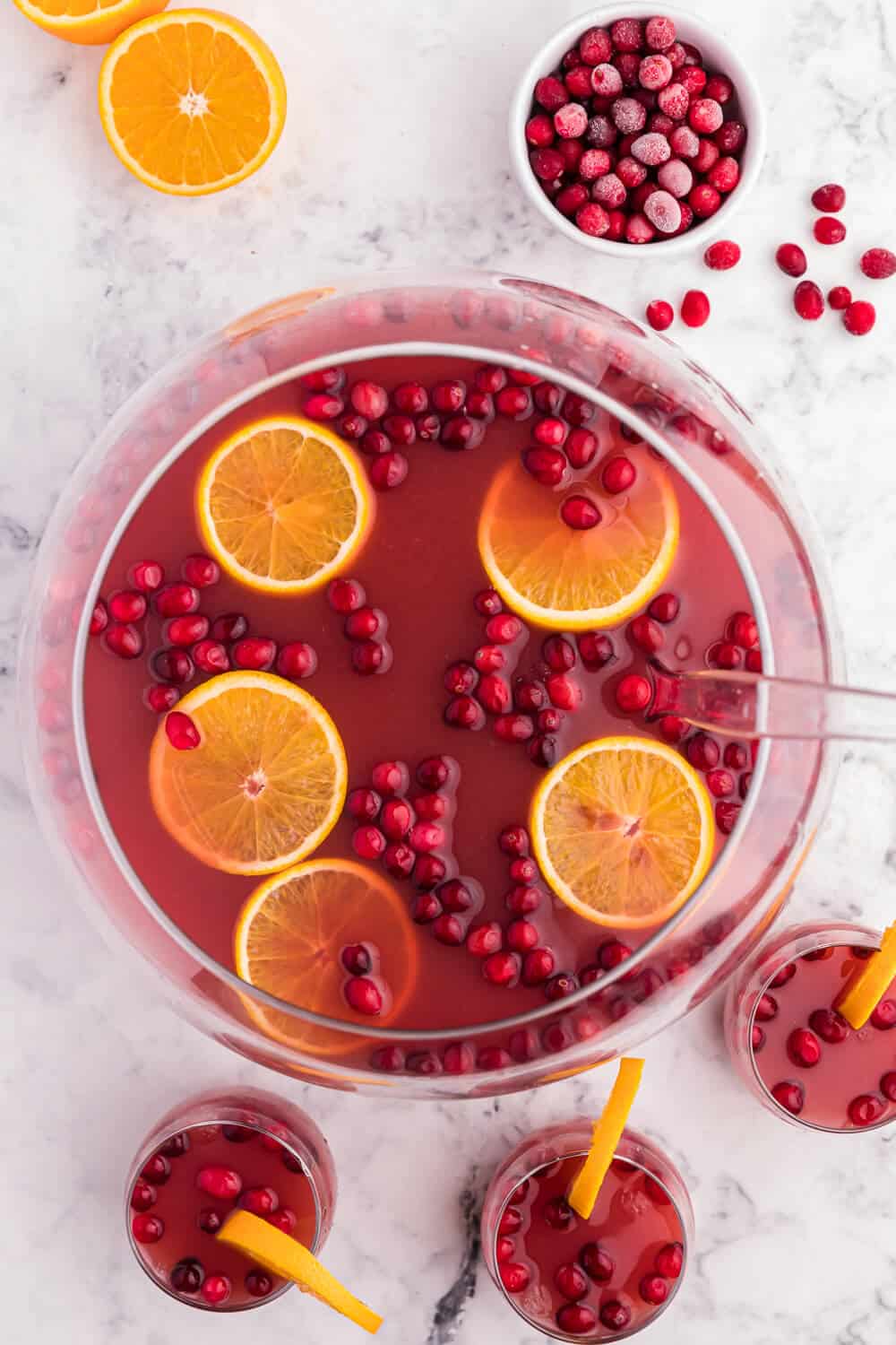 Christmas punch in a punch bowl with glasses and a ladle