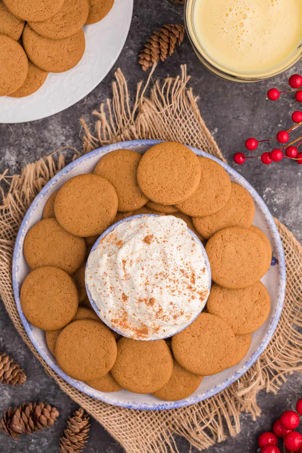 eggnog dip surrounded by gingersnap cookies
