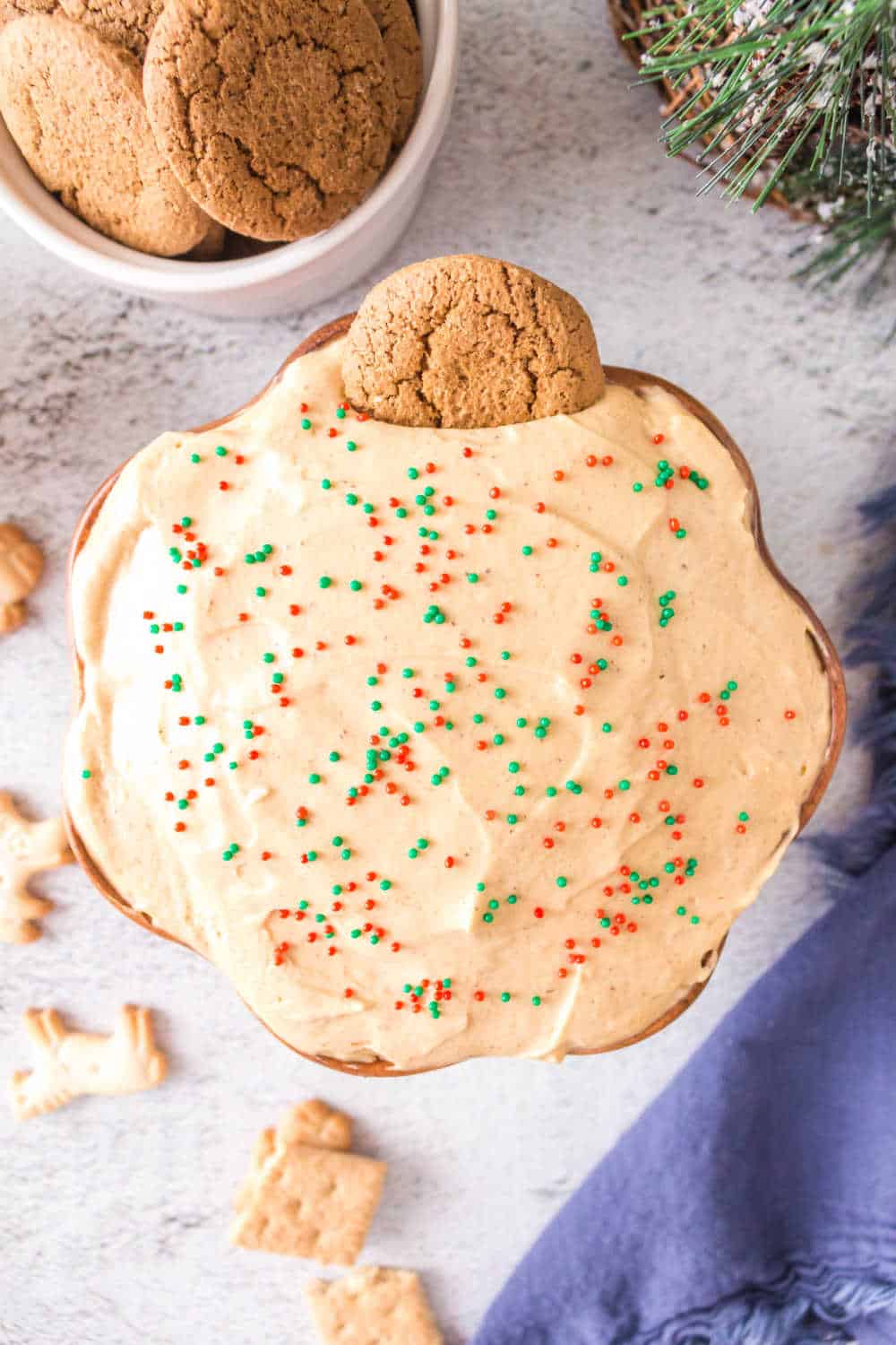 Gingerbread dip in a bowl with a ginger snap cookie in it.