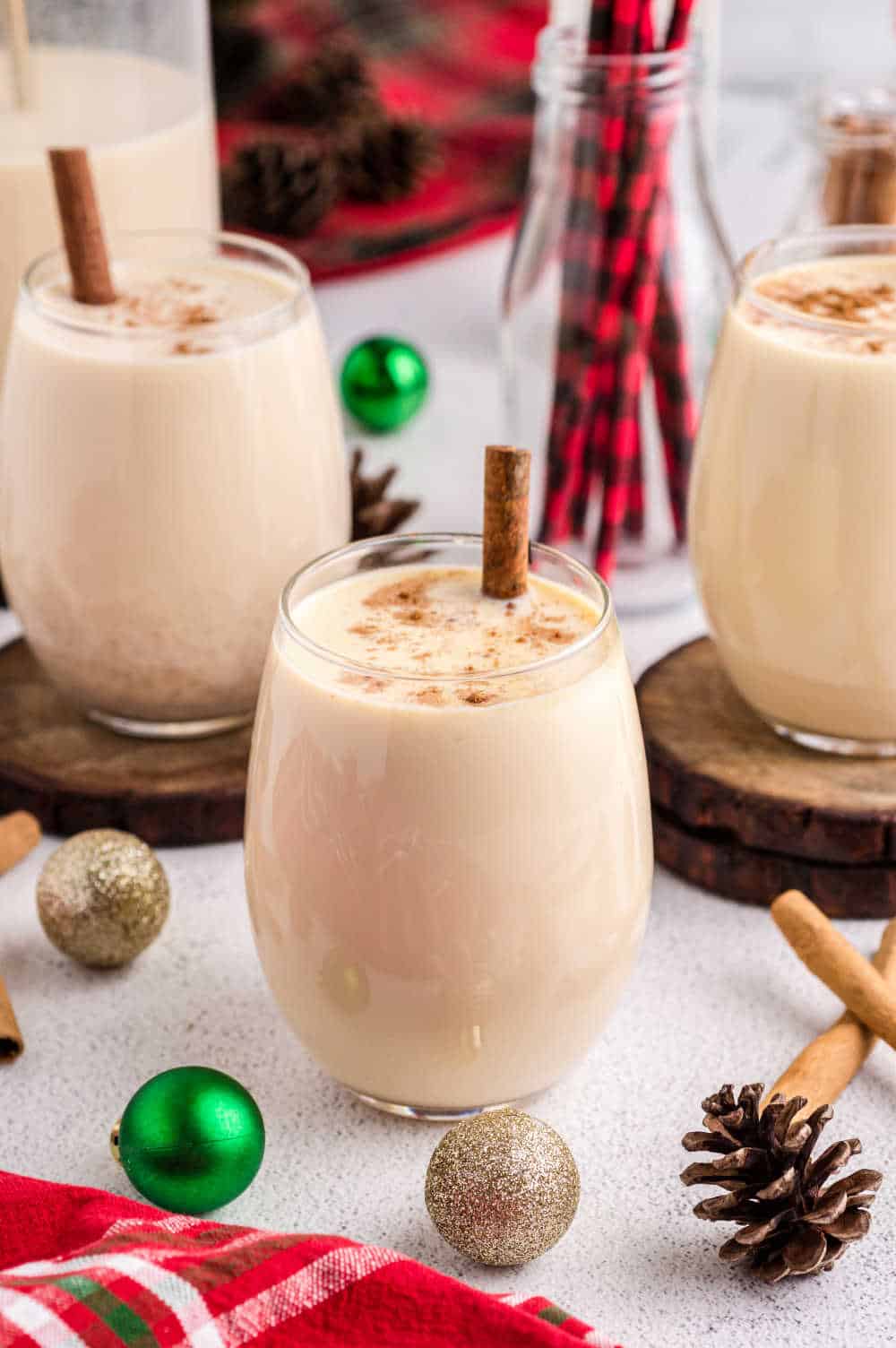 glasses of homemade eggnog with christmas decor on a table